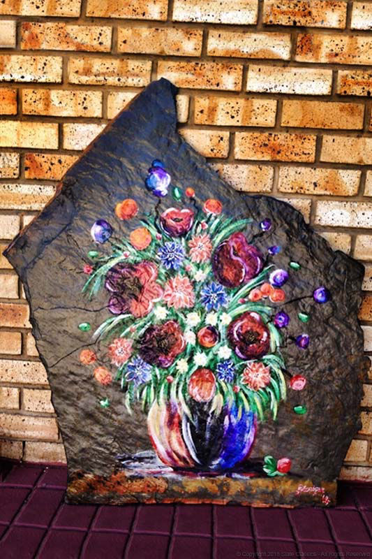 Vase and flowers on slate