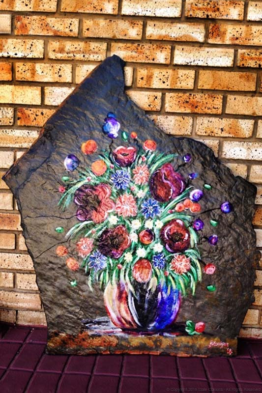 Vase and flowers on slate