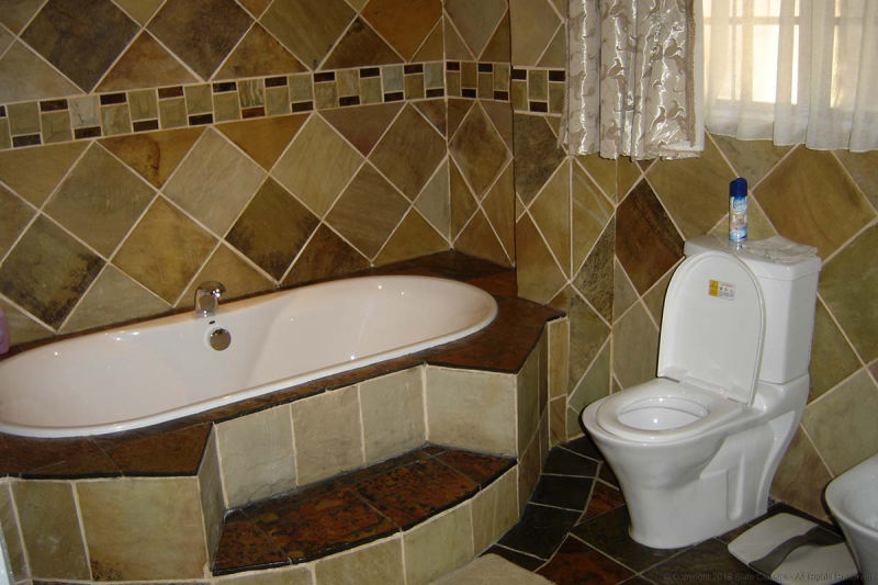 Sandstone & Mosaic tiles in a bathroom