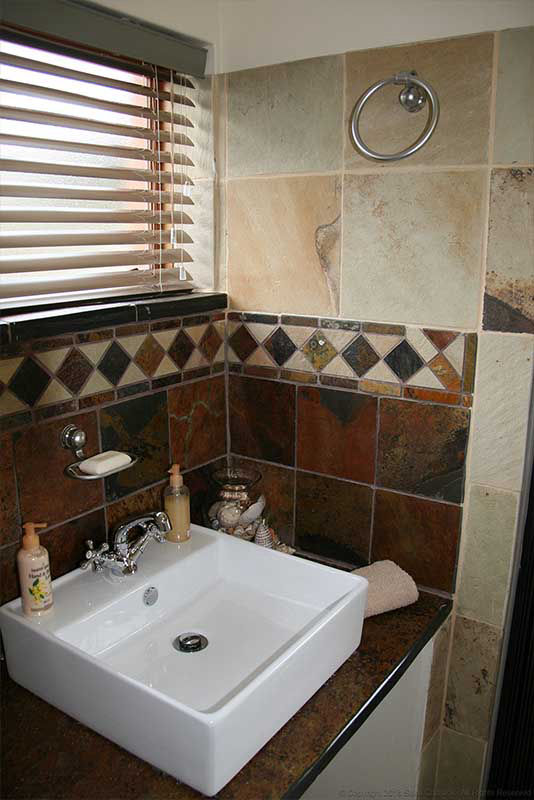 Mosaic & sandstone in a bathroom